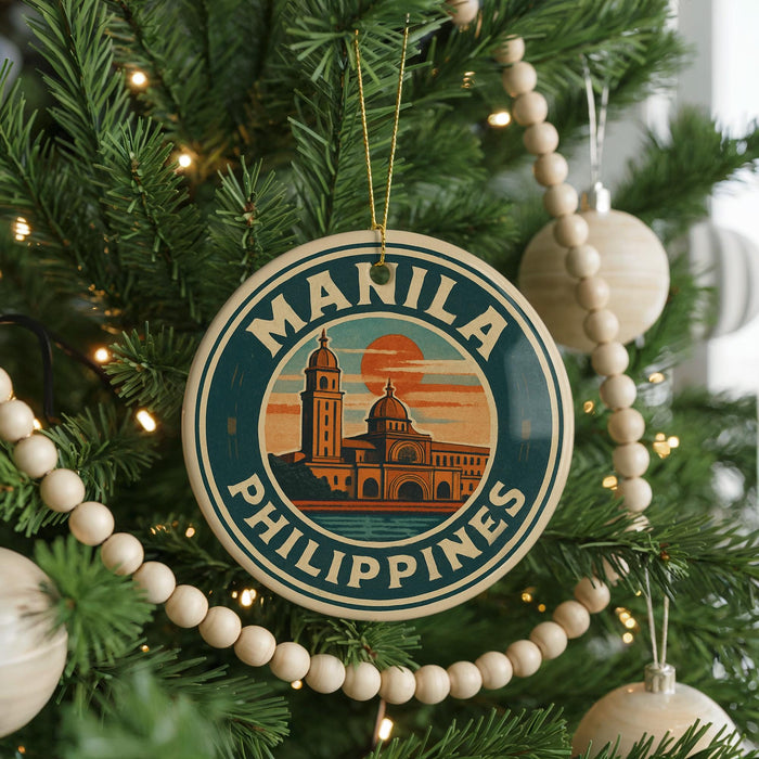 A Christmas tree decorated with ornaments, including a circular ornament with the text "MANILA PHILIPPINES" and a building illustration.