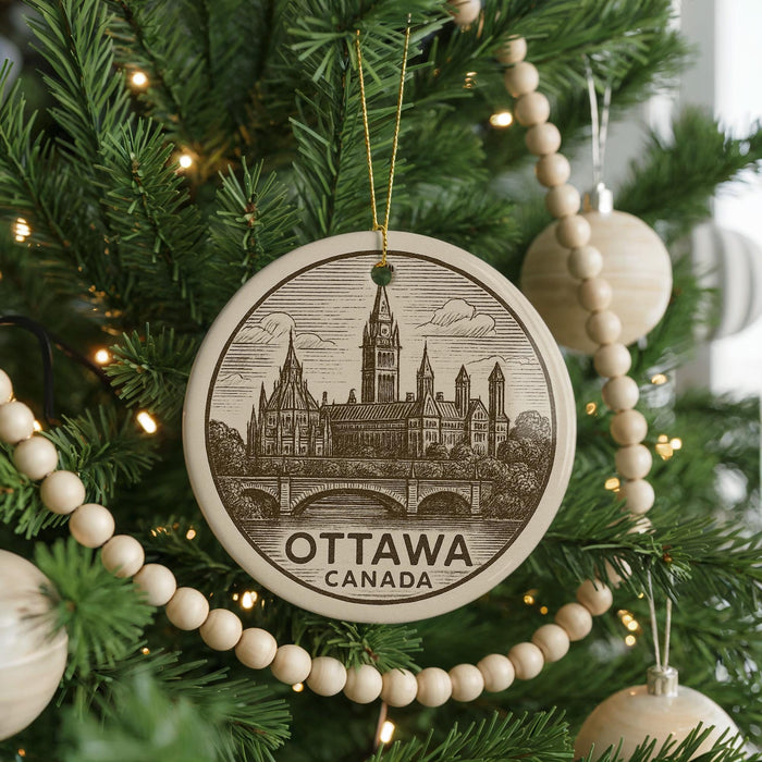 A circular ornament on a Christmas tree, featuring an illustration of the Canadian Parliament building in Ottawa.