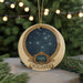 A round ornament with a starry night sky design and the word "PLEIADES" written on it, hanging from a string.