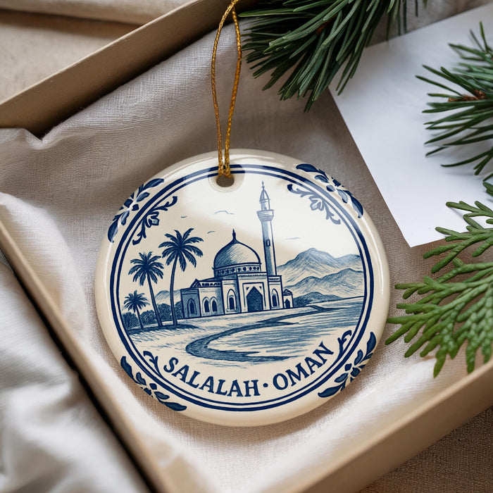 A decorative ornament featuring a mosque and palm trees, with the text "SALALAH - OMAN" around the edge.