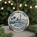 A ceramic ornament featuring a mosque and palm trees, with the text "Salalah - Oman" around the edge.
