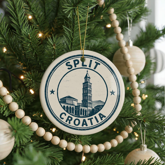 A Christmas tree decorated with ornaments, including a circular ornament with the text "SPLIT" and "C ROMATIA" on it.