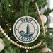 A Christmas tree decorated with ornaments, including a circular ornament with the text "SPLIT" and "C ROMATIA" on it.