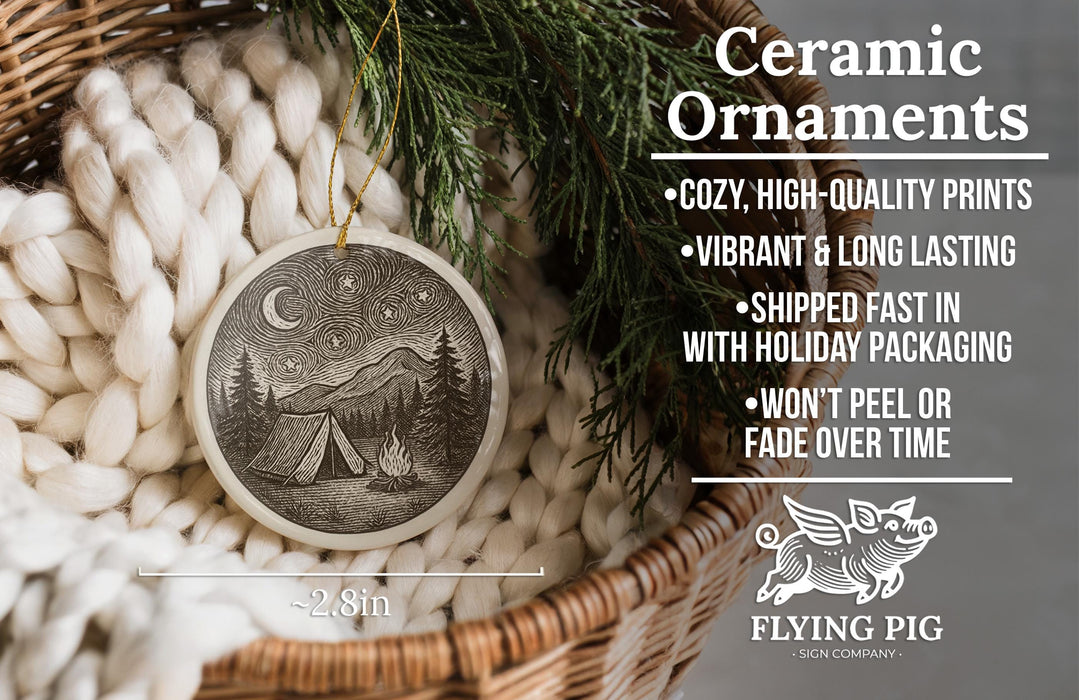 Ceramic ornaments, featuring a night sky scene with a tent and campfire, are displayed in a woven basket.