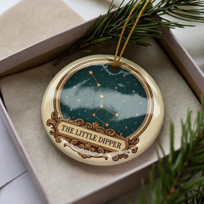 A decorative ornament in a box, featuring a starry night sky design and the text "THE LITTLE DIpper".