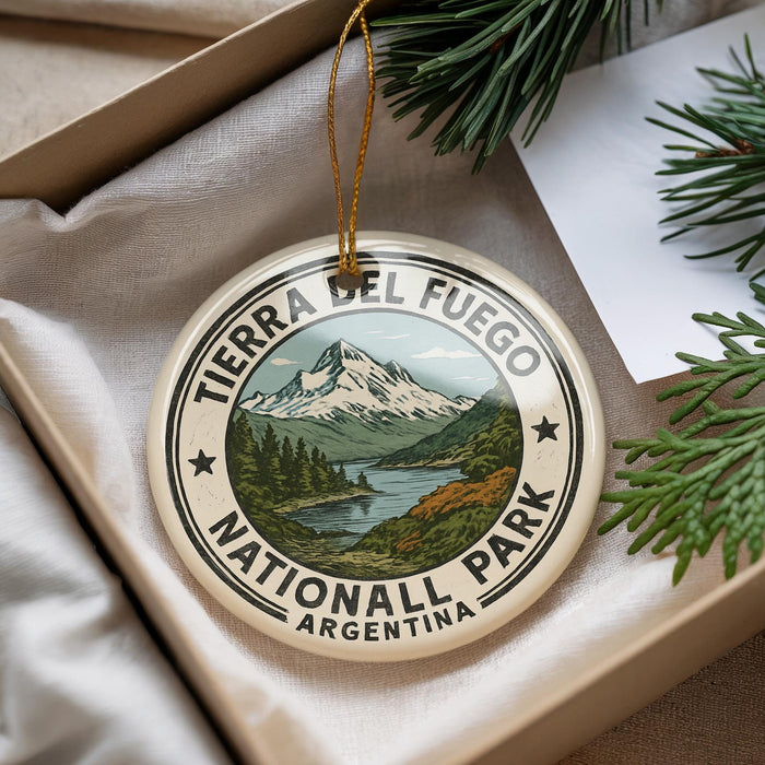 A decorative ornament with a mountain landscape and a river, featuring the text "TERRA DEL FUEGO NATIONALL PARK ARGENTINA" on it.