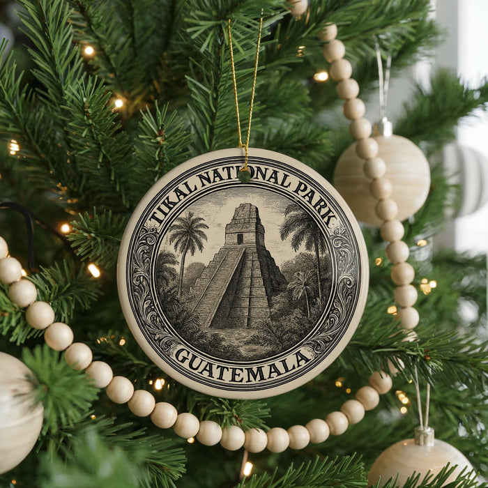 A circular ornament on a Christmas tree, featuring an illustration of the Mayan pyramid of Chichen Itza in Guatemala.