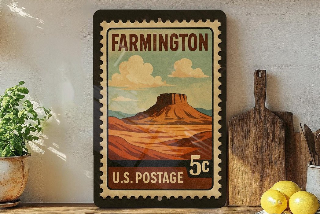 A framed vintage postage stamp depicting a mountain landscape hangs on a wall, surrounded by kitchen utensils and a potted plant.