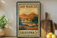 A framed poster of San Marcos, California, depicting a scenic landscape with mountains, buildings, and trees.