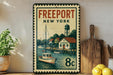 a vintage-style metal sign with a painting of a harbor scene, including boats and buildings, along with the text "FREEPORT NEW YORK MARINA".