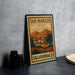 A framed poster of San Marcos, California, depicting a scenic landscape with mountains and buildings.