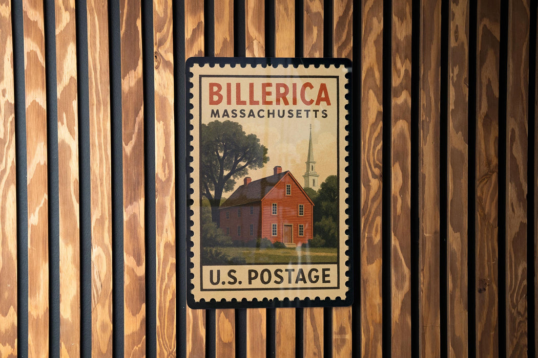 A vintage U.S. postage stamp featuring a red brick house with a steeple, mounted on a wooden wall.