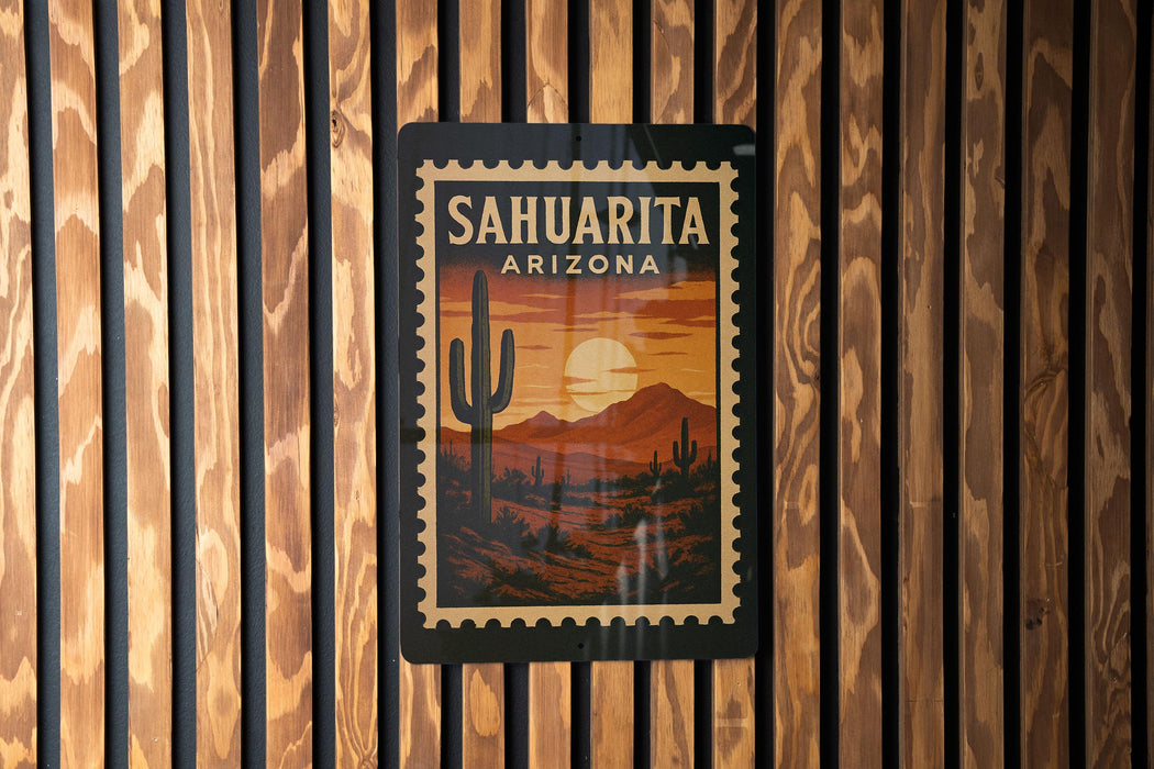 A framed poster of a desert landscape with a cactus and mountains in the background, mounted on a wooden wall.