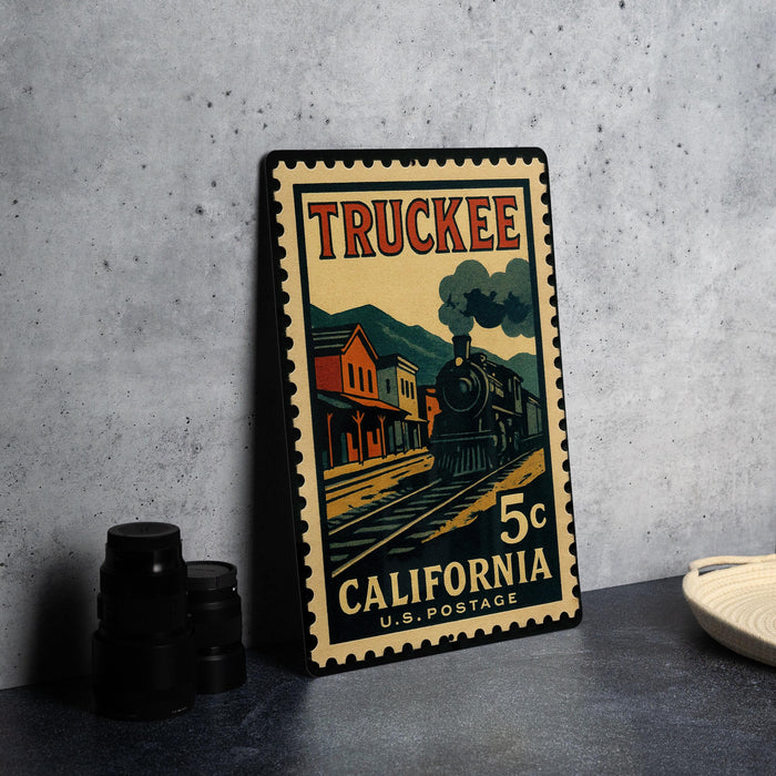 A vintage postage stamp featuring a train on a track, with the text "TRUCKEE" and "5c" printed on it.