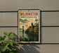 A vintage-style postage stamp from North Carolina, featuring a cityscape and a bridge, is displayed on a wall.