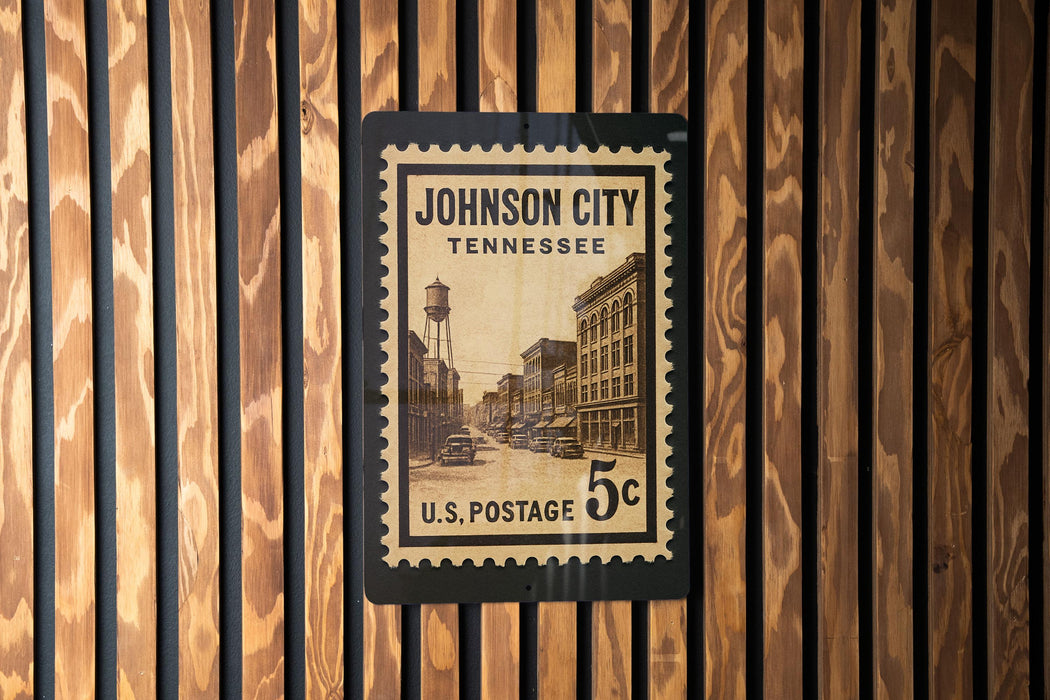 A U.S. postage stamp from Johnson City, Tennessee, mounted on a wooden wall.