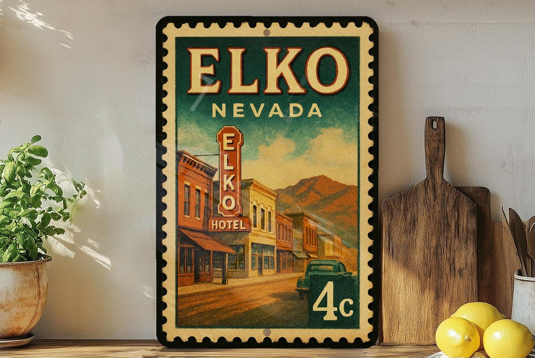 A vintage-style poster of Elko, Nevada, featuring a street scene with buildings, a hotel sign, and a car. The poster is framed and displayed on a shelf, with a wooden cutting board and a potted plant nearby.