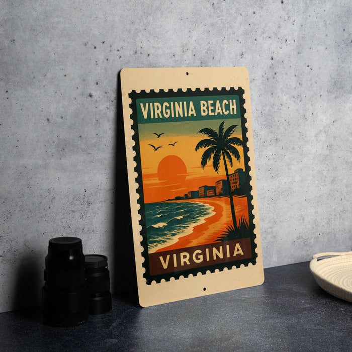 A vintage-style metal sign with a tropical beach scene and the text "VIRGINIA BEACH" is displayed on a gray wall.