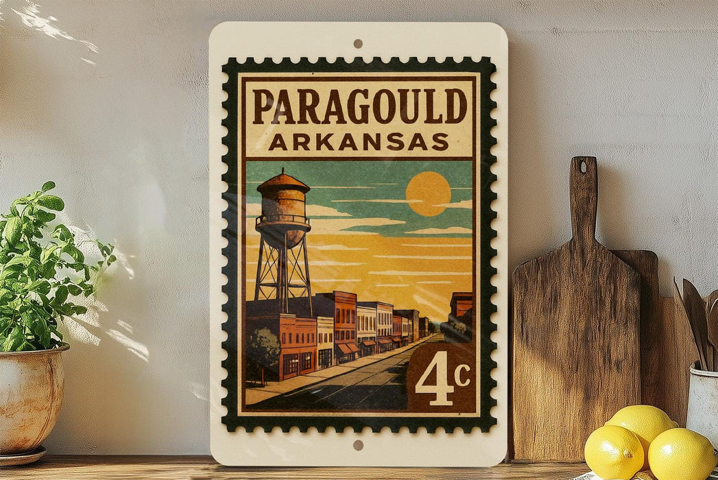 A vintage-style postage stamp from Arkansas featuring a water tower and a street scene, with the text "PARAGOUD ARKANSAS" printed on it.