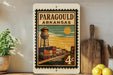 A vintage-style postage stamp from Arkansas featuring a water tower and a street scene, with the text "PARAGOUD ARKANSAS" printed on it.