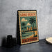 A vintage-style metal sign with a beach scene and palm trees, featuring the text "LONG BEACH" and "CALIFORNIA" on it, is displayed on a table.