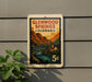 A postage stamp-like sign for Glenwood Springs, Colorado, featuring a scenic mountain landscape with a bridge and river.