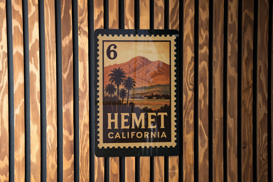 A California postage stamp with the number 6 on it, displayed on a wooden wall.