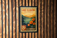 A vintage-style postage stamp for Lake Elsinore, California, featuring a scenic landscape with mountains, a lake, and orange flowers.