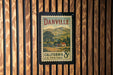 A vintage California U.S. postage stamp is displayed on a wooden wall.