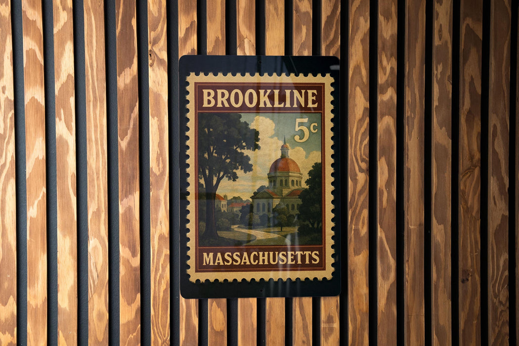 A vintage-style postage stamp from Massachusetts, featuring a building with a dome and trees, mounted on a wooden wall.