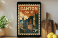 A vintage-style postage stamp from Canton, Ohio, featuring an illustration of the city's skyline and buildings.
