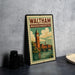 A vintage-style metal sign with the text "WALTHAM MASSACHUSETTS" and an illustration of a clock tower and a river, placed on a gray concrete surface.
