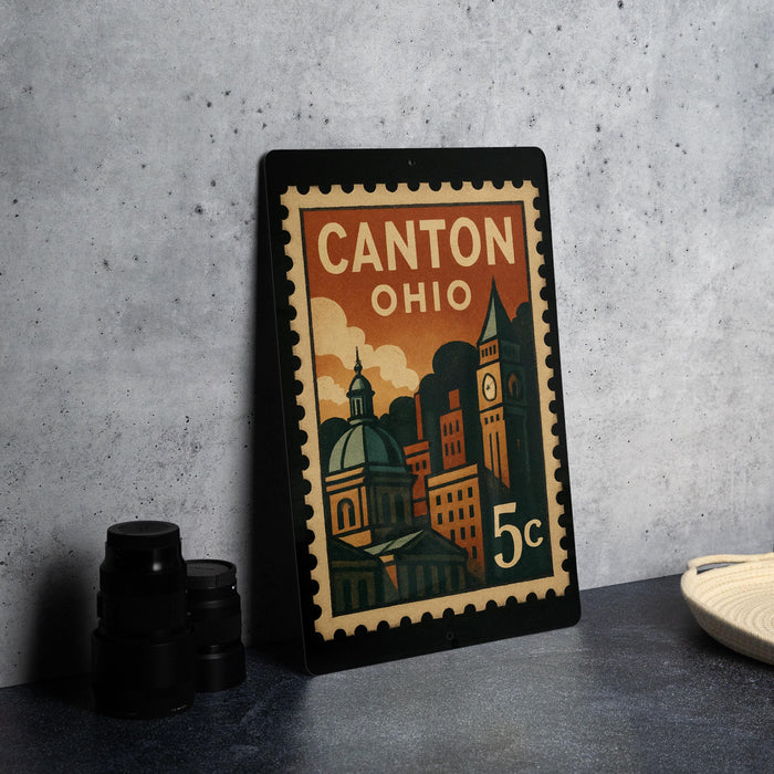 A framed vintage postage stamp from Canton, Ohio, featuring an illustration of the city's skyline and landmarks.