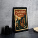 A framed vintage postage stamp from Canton, Ohio, featuring an illustration of the city's skyline and landmarks.