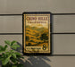 A framed postage stamp from California, featuring a scenic landscape of hills and trees, is displayed on a wall.