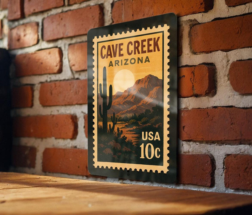 A vintage-style postage stamp featuring a desert landscape with a cactus and mountains, mounted on a brick wall.