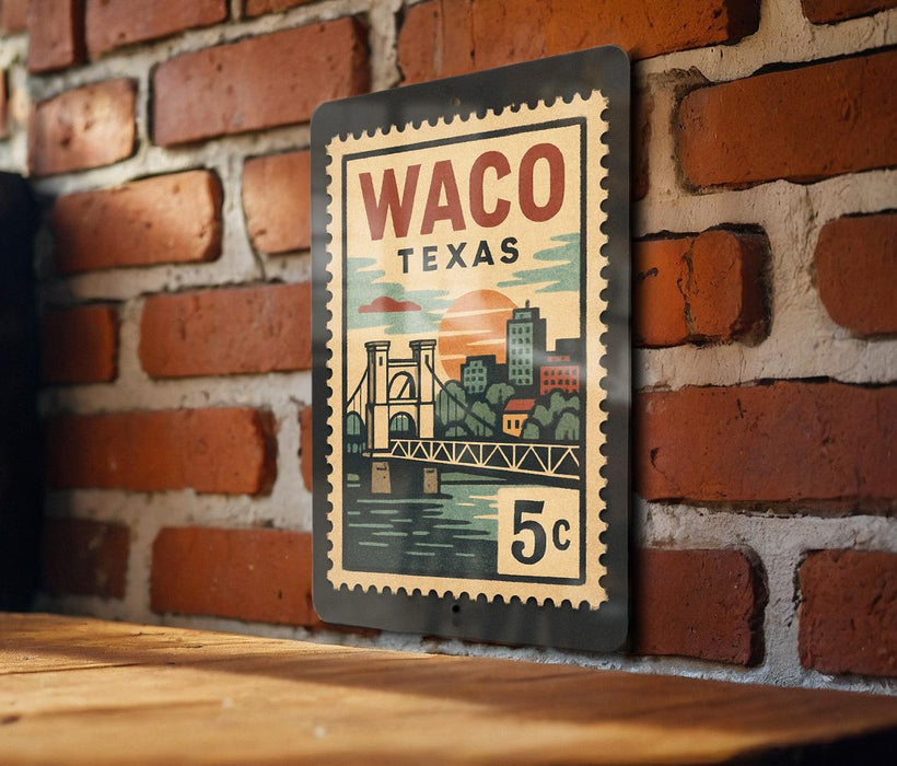 A vintage-style metal stamp depicting a bridge and cityscape, with the text "Waco, Texas" and "5c" printed on it, is hanging on a brick wall.