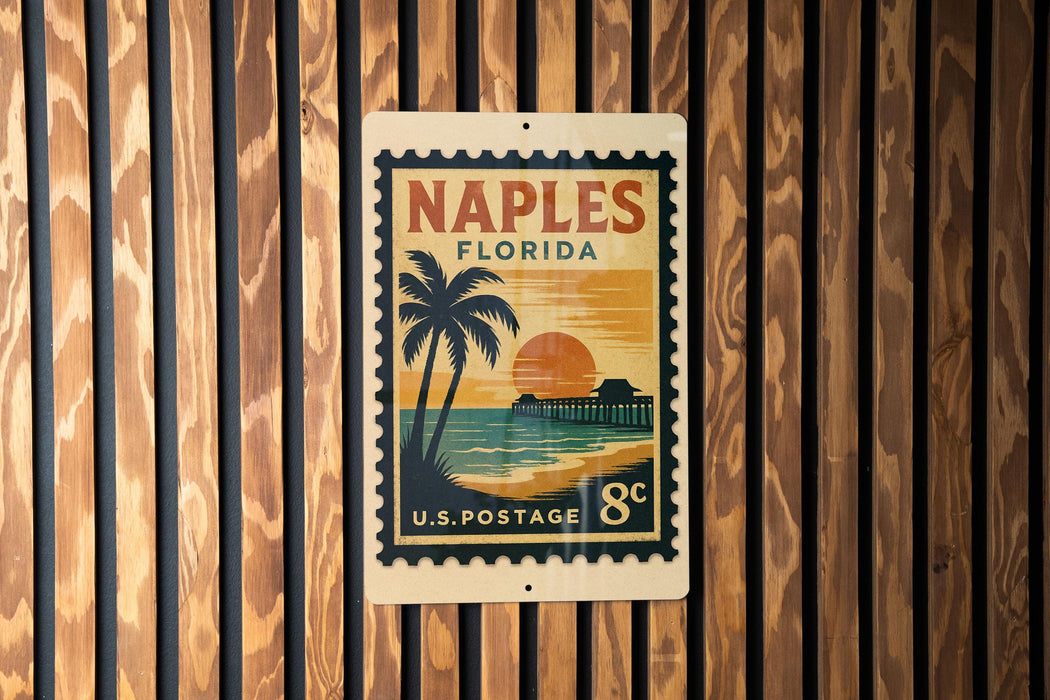 A vintage-style postage stamp from the United States, featuring a palm tree and a sunset, is displayed on a wooden wall.