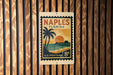 A vintage-style postage stamp from the United States, featuring a palm tree and a sunset, is displayed on a wooden wall.