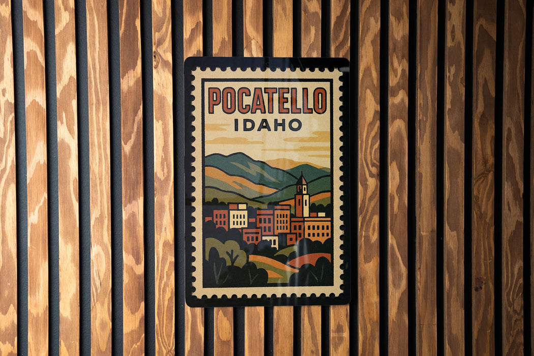 A vintage-style poster of POCATELLO, Idaho, displayed on a wooden wall.