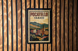 A vintage-style poster of POCATELLO, Idaho, displayed on a wooden wall.