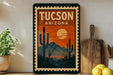 A framed poster of a desert landscape with a cactus and mountains in the background, along with a wooden cutting board and a potted plant.