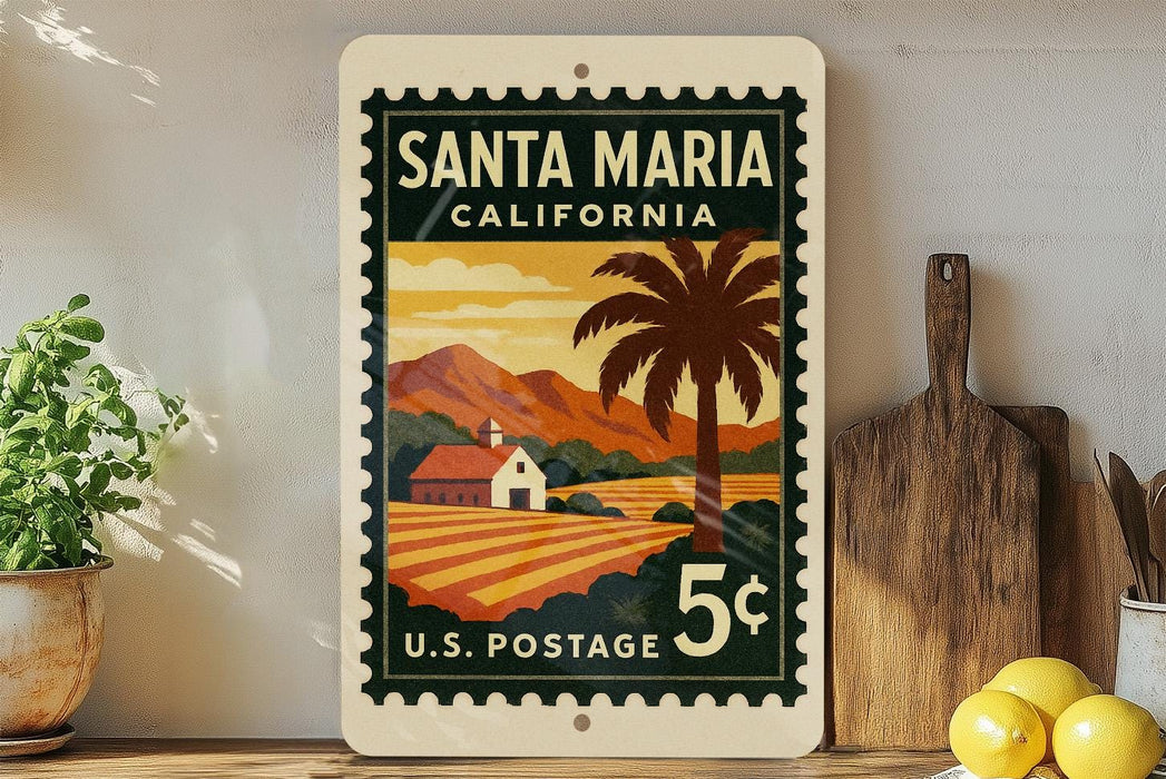 A vintage-style postage stamp from Santa Maria, California, featuring a rural landscape with a palm tree and a house, displayed on a shelf next to a wooden cutting board and some lemons.