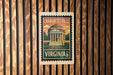 A vintage postage stamp featuring the University of Virginia, with the text "CHARLOTTSVILLE" and "VIRGINIA US 8c" prominently displayed.