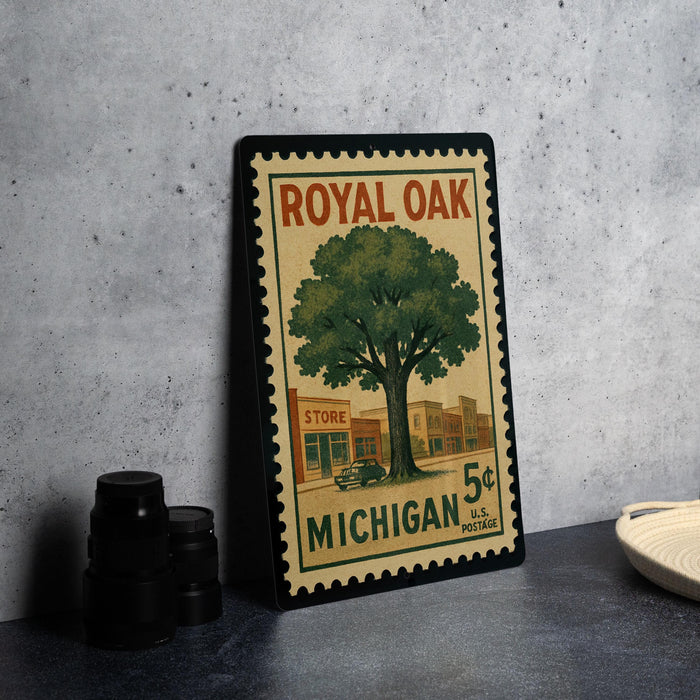 A vintage-style postage stamp featuring a tree and a store, with the text "ROYAL OAK" and "MICHIGAN 5¢ POSTAGE" printed on it.