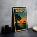 A vintage-style metal stamp depicting a sunset over a body of water, with the text "FAIRHOPE ALABAMA 5¢" printed on it.