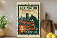 A vintage-style postage stamp from Kentucky featuring a horse silhouette and a cityscape, placed on a wooden surface next to a wooden cutting board and some lemons.