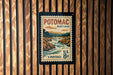 A vintage-style postage stamp from the United States, featuring a scenic landscape of Potomac, Maryland.