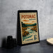 A vintage-style postage stamp from Potomac, Maryland, featuring a scenic landscape with a river and mountains.