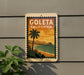 A vintage-style sign for Goleta, California, featuring a palm tree and a beach scene with a pier in the background.